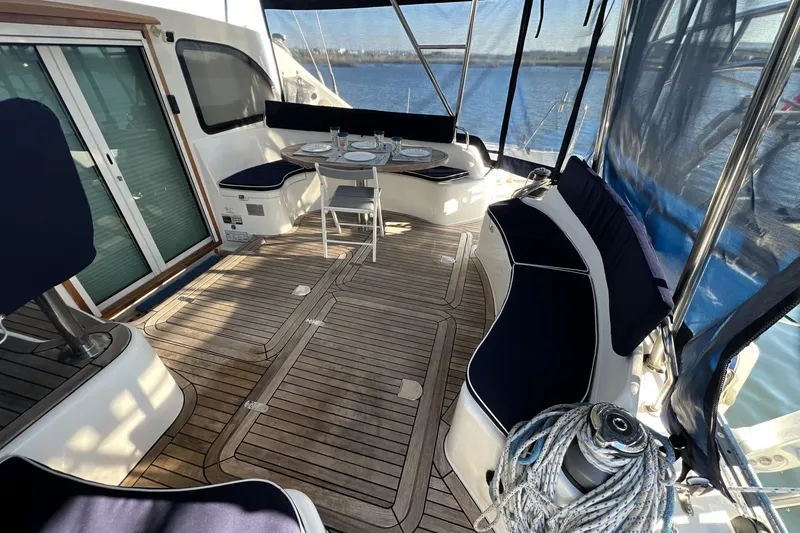 Slide: The Image of Spacious deck of 2011 Privilege 495 yacht with seating and dining area. - 42