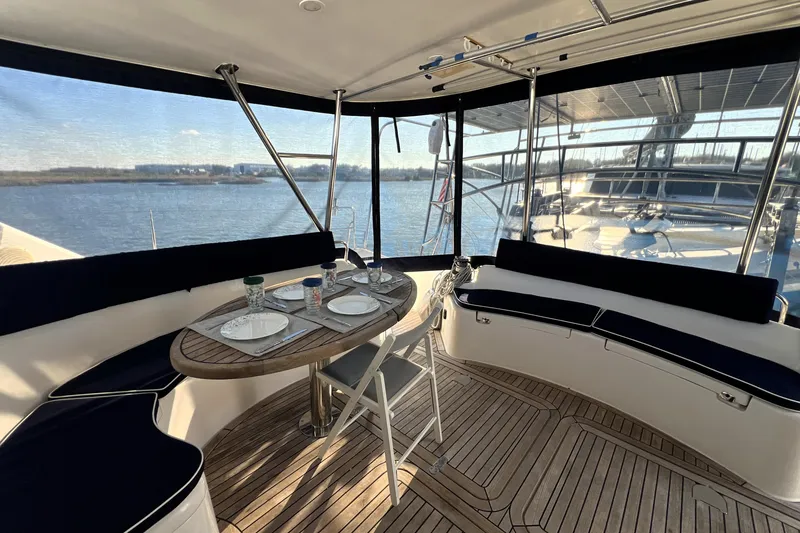 Slide: The Image of Luxurious 2011 Privilege 495 yacht interior with elegant dining setup and panoramic water views. - 43