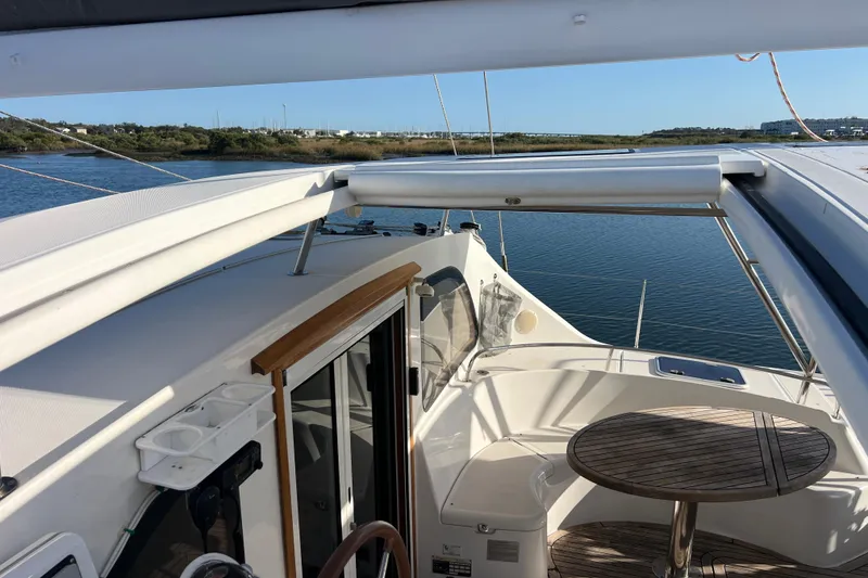 Slide: The Image of Luxury Privilege 495 yacht deck with seating, table, and scenic water view, 2011 model. - 47