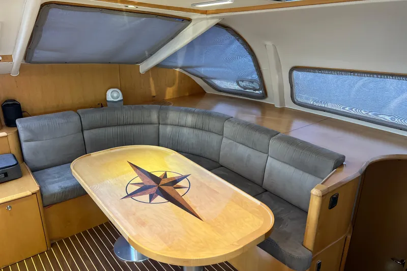 Slide: The Image of Luxurious interior of 2011 Privilege 495 yacht with elegant seating and compass-themed table. - 60