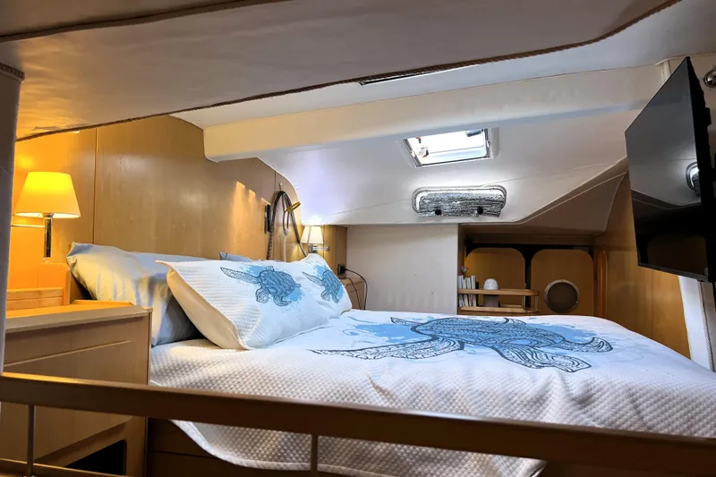 Slide: The Image of Luxurious cabin interior of 2011 Privilege 495 yacht with cozy bedding and ambient lighting. - 71