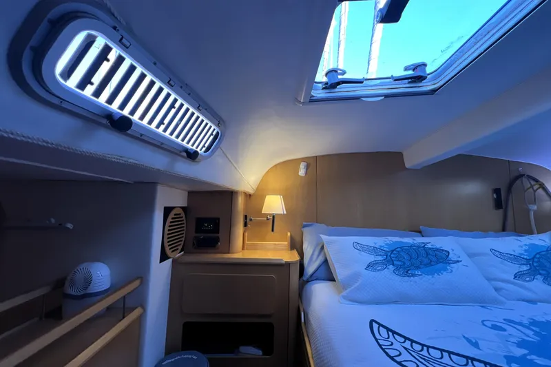 Slide: The Image of Cozy cabin interior of 2011 Privilege 495 yacht with nautical-themed bedding. - 76