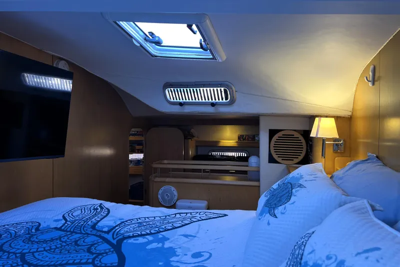 Slide: The Image of Luxurious cabin interior of 2011 Privilege 495 yacht with cozy bedding and ambient lighting. - 77