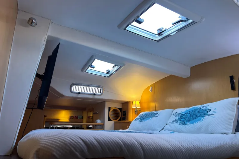 Slide: The Image of Luxurious cabin interior of 2011 Privilege 495 yacht with skylights and cozy bedding. - 80