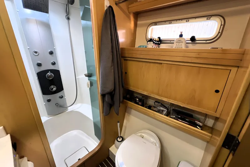 Slide: The Image of Luxurious 2011 Privilege 495 yacht bathroom with modern shower and wooden cabinetry. - 82