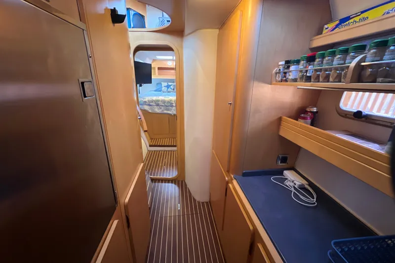 Slide: The Image of Interior of 2011 Privilege 495 yacht with wooden cabinetry and spice rack. - 87