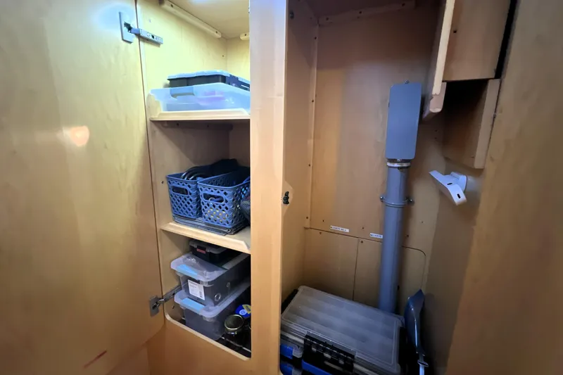 Slide: The Image of Storage cabinet in 2011 Privilege 495 yacht with organized shelves and containers. - 89