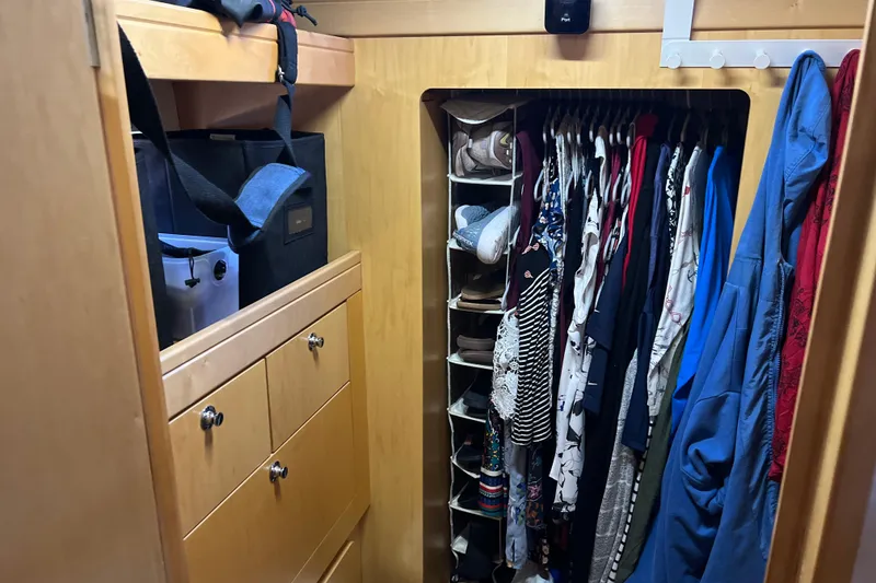 Slide: The Image of Closet in 2011 Privilege 495 yacht with clothes and shoe organizer. - 91