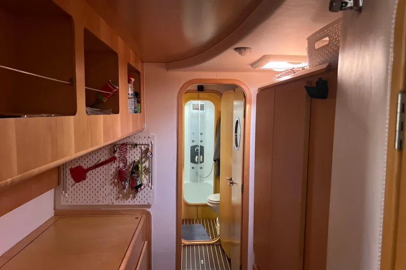 Slide: The Image of Interior of 2011 Privilege 495 yacht with wooden cabinetry and bathroom view. - 92