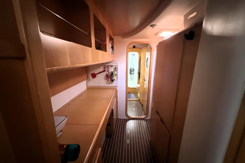 Slide: The Image of Interior of 2011 Privilege 495 yacht with wooden cabinetry and hallway view. - 94