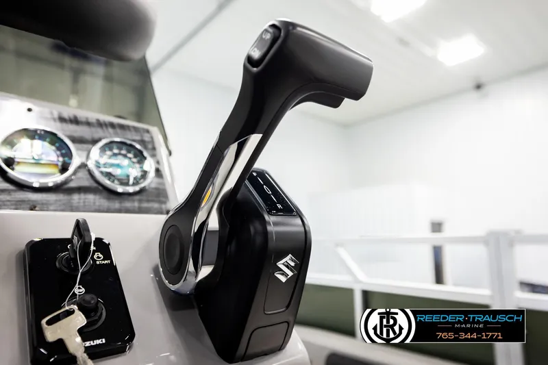 Slide: The Image of Close-up of Avalon VEN85 CCF 2026 boat controls with Suzuki key and gauges. - 38