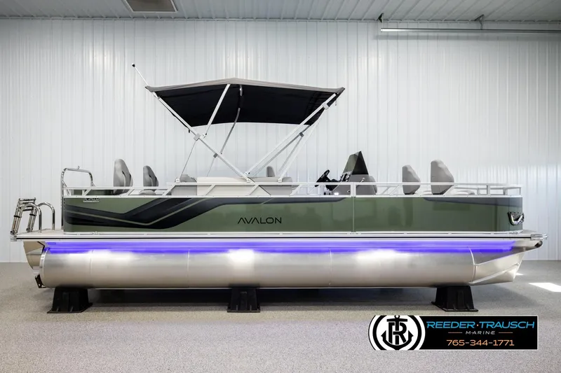 Slide: The Image of 2026 Avalon VEN85 CCF pontoon boat with canopy, displayed indoors, featuring sleek design and blue underglow. - 5
