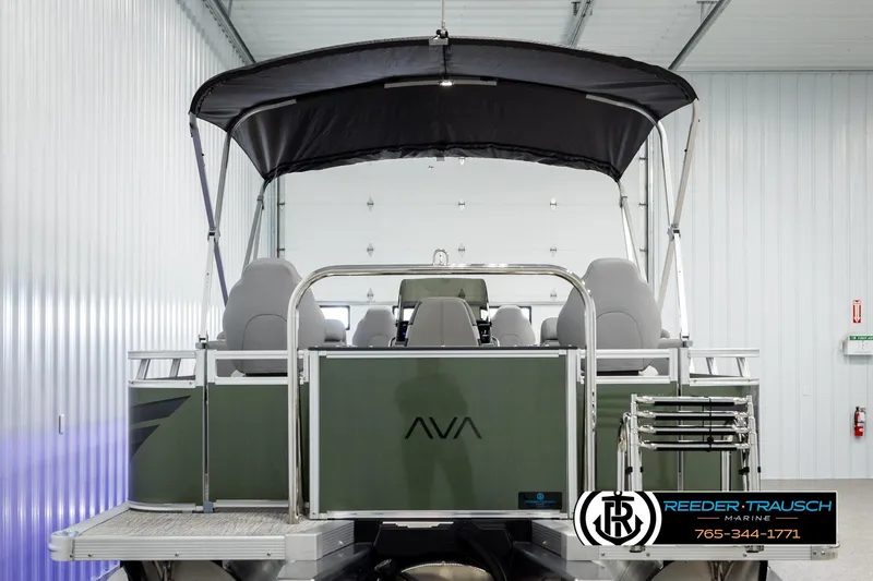 Slide: The Image of 2026 Avalon VEN85 CCF pontoon boat in showroom, featuring sleek design and canopy. - 7