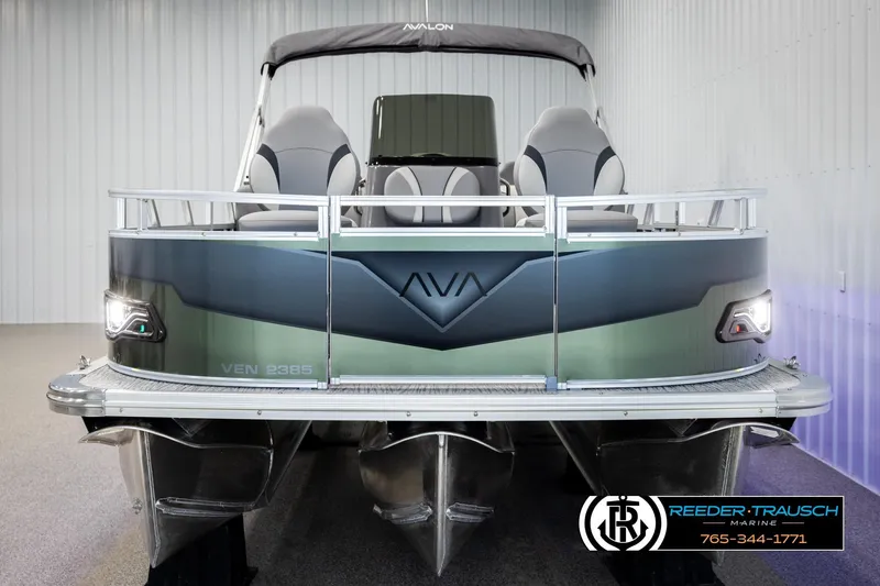 Slide: The Image of 2026 Avalon VEN85 CCF pontoon boat in showroom, front view with sleek design. - 8