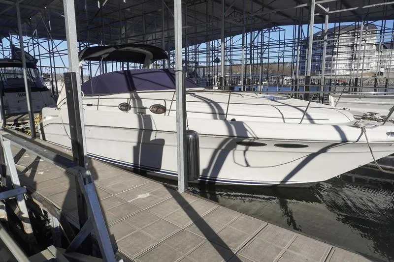 The Image of 2001 Sea Ray 340 Sundancer docked in a covered marina. - 0