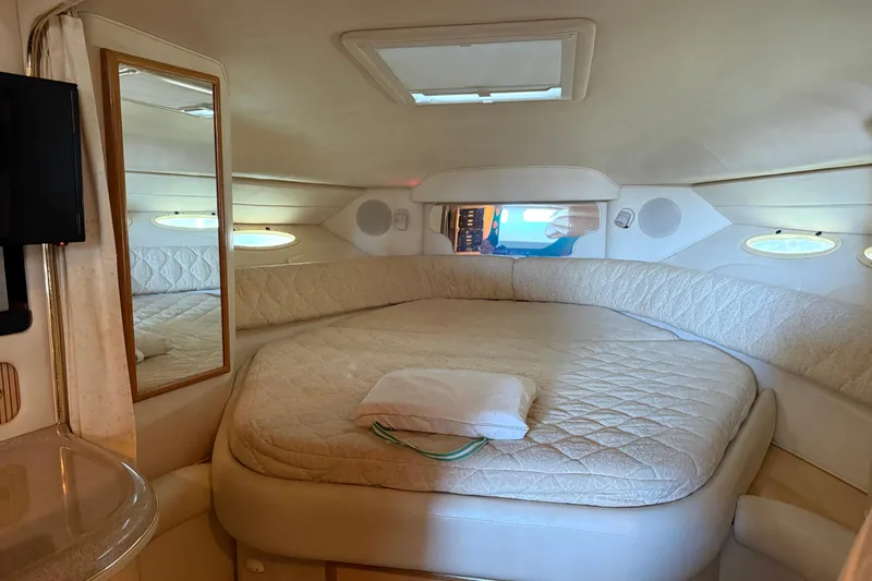 Slide: The Image of 2001 Sea Ray 340 Sundancer cabin interior with cozy bed and mirror. - 12