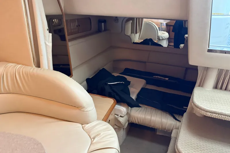 Slide: The Image of Interior cabin of 2001 Sea Ray 340 Sundancer with beige seating and cozy sleeping area. - 15