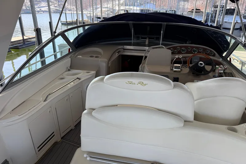 Slide: The Image of Interior of 2001 Sea Ray 340 Sundancer yacht with helm and seating area. - 4
