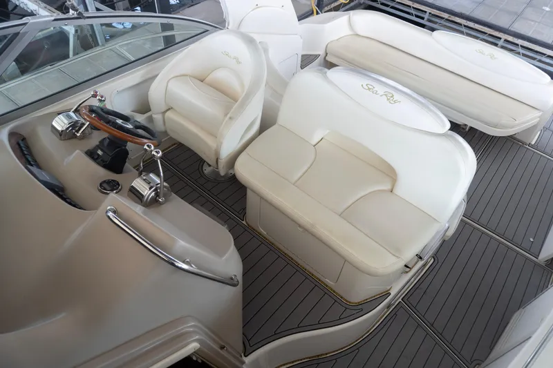 Slide: The Image of 2001 Sea Ray 340 Sundancer cockpit with beige seating and helm controls. - 9