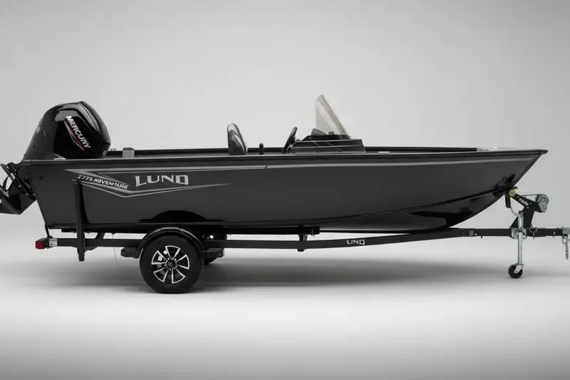 The Image of 2025 Lund 1775 Adventure SS boat on trailer, side view, sleek black design. - 0