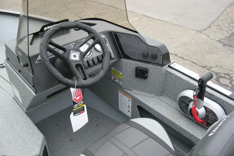 Slide: The Image of 2025 Lund 1775 Adventure SS boat cockpit with steering wheel and control panel. - 10