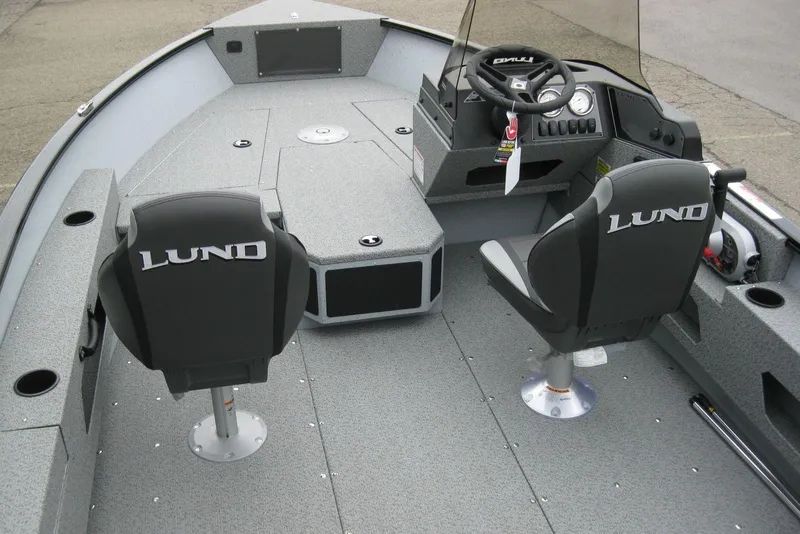 Slide: The Image of 2025 Lund 1775 Adventure SS boat interior with steering console and two seats. - 4