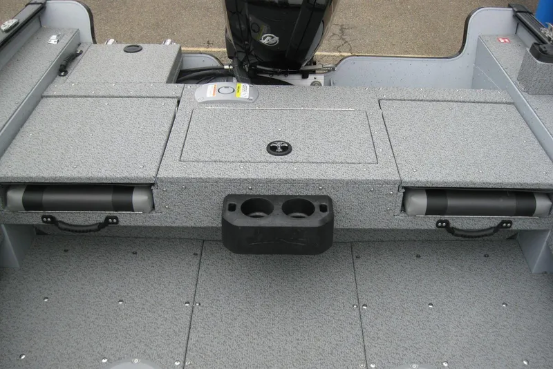 Slide: The Image of 2025 Lund 1775 Adventure SS boat interior with storage compartments and cup holders. - 5