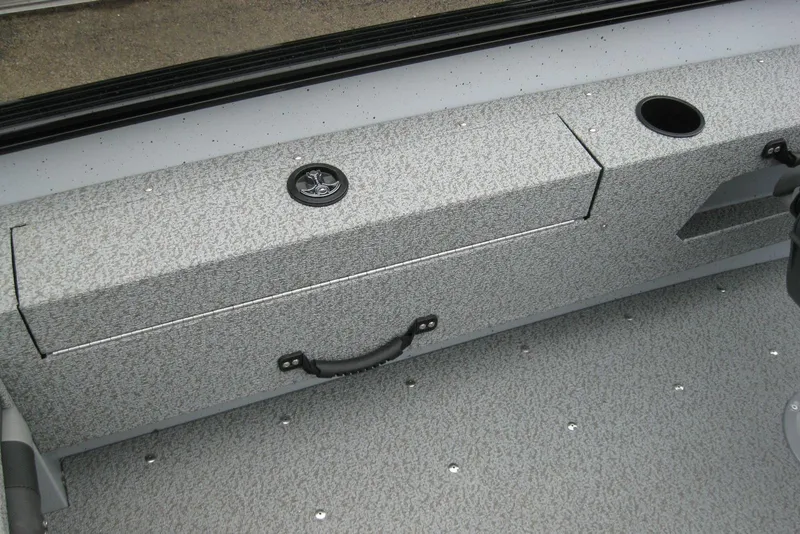Slide: The Image of 2025 Lund 1775 Adventure SS boat interior with textured storage compartment and cup holder. - 7