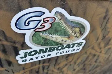 Slide: The Image of Sticker on 2021 G3 Gator Tough 18 CCJ DLX boat featuring an alligator graphic. - 12