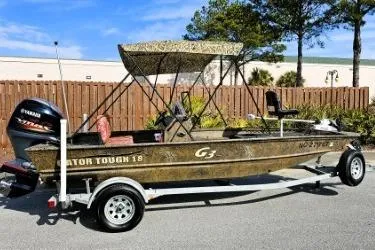 Slide: The Image of 2021 G3 Gator Tough 18 CCJ DLX boat on trailer, featuring camouflage design and Yamaha outboard motor. - 3