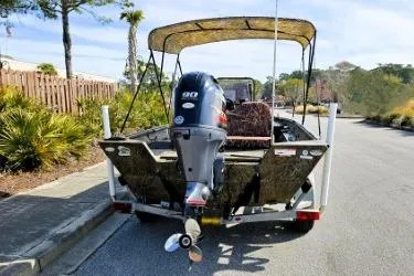 Slide: The Image of 2021 G3 Gator Tough 18 CCJ DLX boat with canopy and outboard motor on trailer. - 9