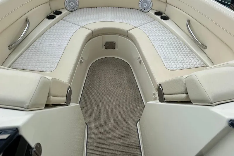 Slide: The Image of 2020 Chris-Craft Launch 28 boat with luxurious seating, docked by a serene waterway. - 14