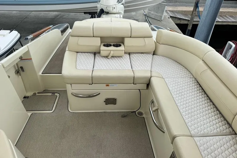 Slide: The Image of 2020 Chris-Craft Launch 28 boat docked by a scenic waterway. - 16