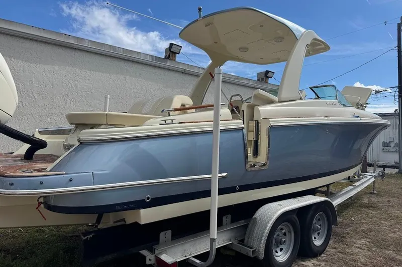 Slide: The Image of 2020 Chris-Craft Launch 28 boat with elegant beige seating and wooden accents. - 20