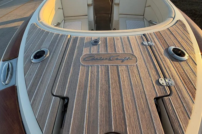 Slide: The Image of 2020 Chris-Craft Launch 28 dashboard with Garmin navigation and classic wooden steering wheel. - 25