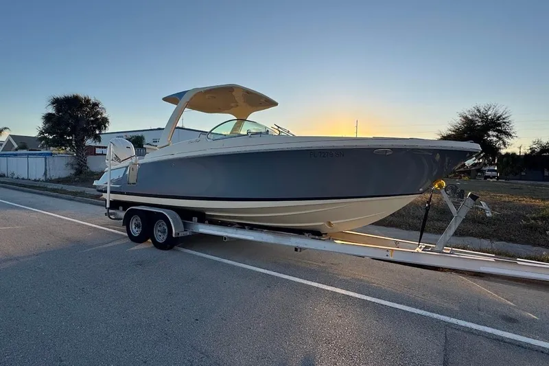 Slide: The Image of 2020 Chris-Craft Launch 28 boat with beige cushioned seating, docked on water. - 37