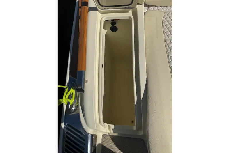 Slide: The Image of 2020 Chris-Craft Launch 28 boat storage compartment with beige interior and wooden accents. - 38