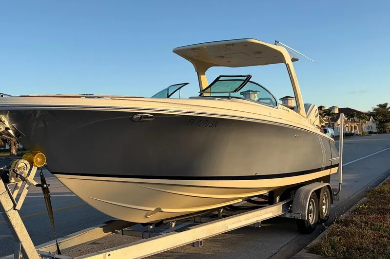 Slide: The Image of 2020 Chris-Craft Launch 28 boat on trailer, parked on a sunny street. - 42