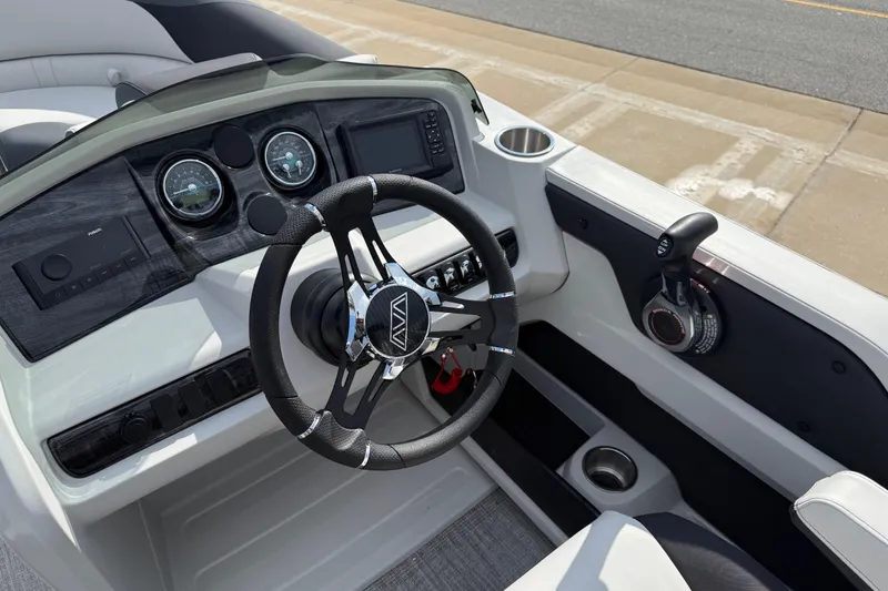 Slide: The Image of 2026 Avalon LSZ Quad Lounge Shift boat dashboard with steering wheel and controls. - 20