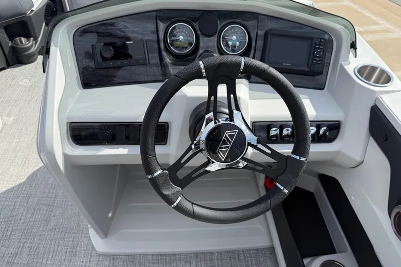 Slide: The Image of 2026 Avalon LSZ Quad Lounge Shift boat dashboard with steering wheel and controls. - 21