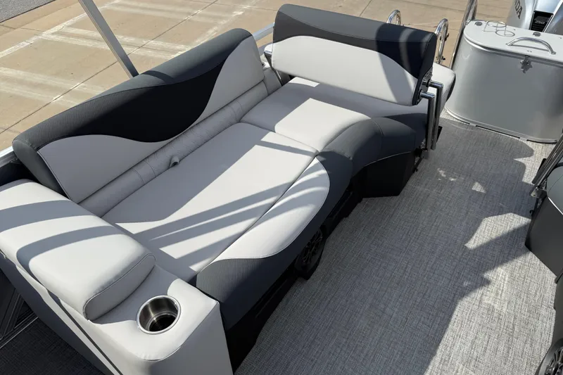 Slide: The Image of 2026 Avalon LSZ Quad Lounge Shift boat interior with plush seating and cup holder. - 27
