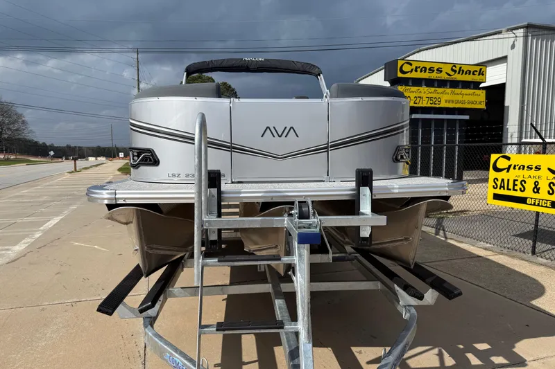 Slide: The Image of 2026 Avalon LSZ Quad Lounge Shift pontoon boat on trailer at dealership. - 3