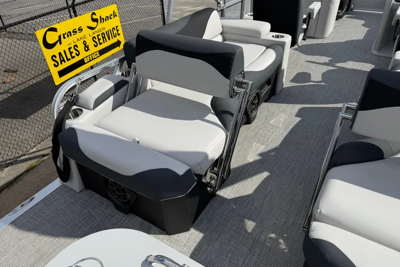 Slide: The Image of 2026 Avalon LSZ Quad Lounge Shift boat interior with plush seating and sales sign. - 33