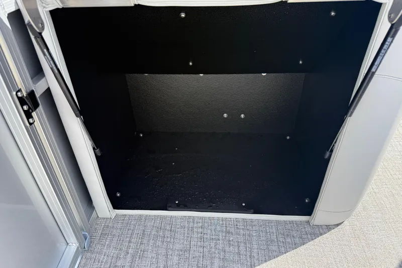 Slide: The Image of Open storage compartment in 2026 Avalon LSZ Quad Lounge Shift boat. - 44