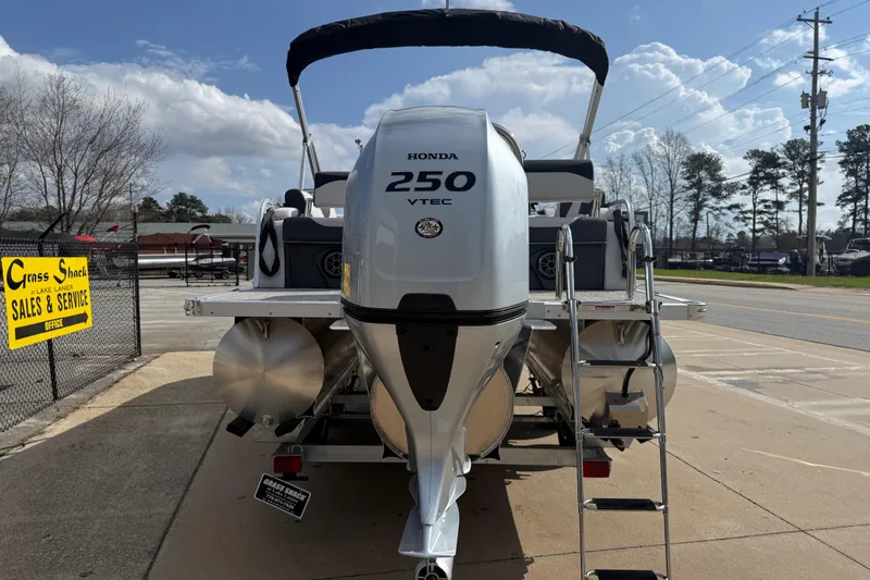 Slide: The Image of 2026 Avalon LSZ Quad Lounge Shift boat with Honda 250 VTEC engine at sales lot. - 6