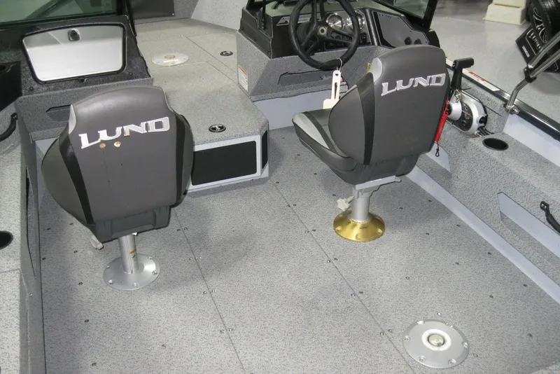 Slide: The Image of 2025 Lund 1775 Adventure Sport boat interior with two swivel seats and steering console. - 3