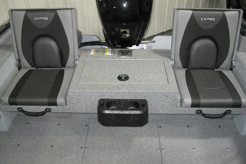 Slide: The Image of 2025 Lund 1775 Adventure Sport boat interior with two gray seats and storage compartment. - 5