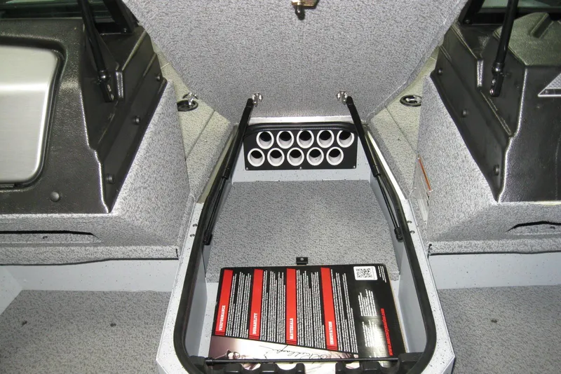 Slide: The Image of 2025 Lund 1775 Adventure Sport boat interior storage compartment with rod holders. - 8