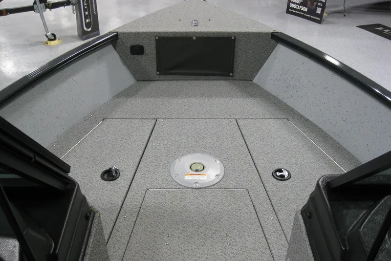Slide: The Image of 2025 Lund 1775 Adventure Sport boat interior with gray speckled flooring and storage compartments. - 9