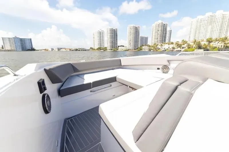 Slide: The Image of 2021 Cruisers Yachts 38 GLS OB with luxurious seating, city skyline in background. - 12